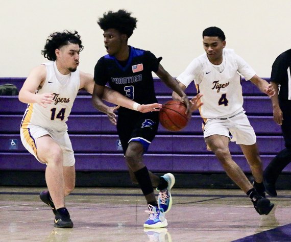 Lemoore's Donovan Johnson (14) and Beunju Moon (4) grab for the ball from Frontier's Jaden Perez in Tuesday night's playoff opener.